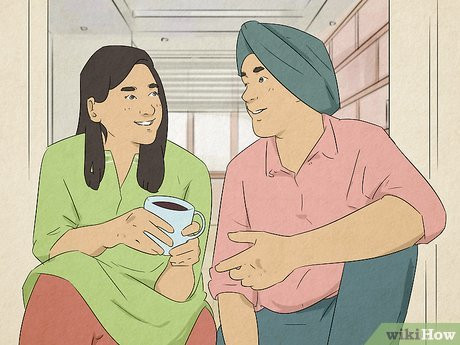 A couple smiling and having a conversation.